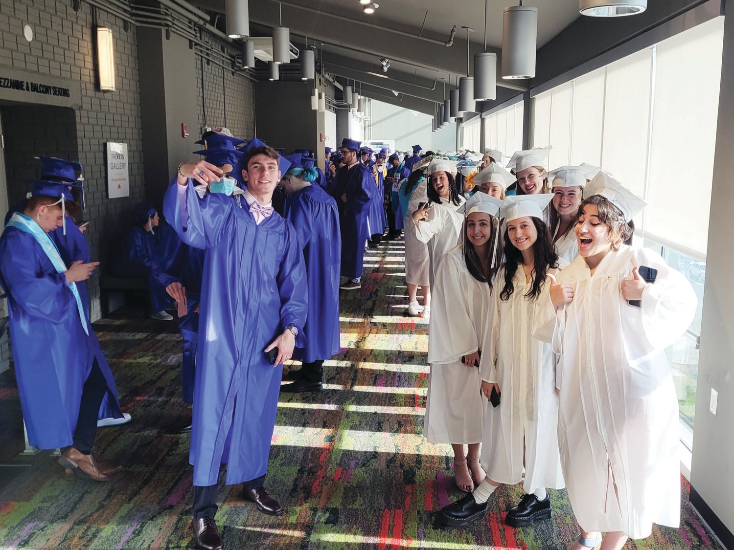 ANXIOUS GRADS: The Johnston Senior High School Class of 2022 lined up in a hallway behind the scenes of the ceremony held Friday at Veterans Memorial Auditorium in Providence.